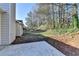 View of the side yard and backyard featuring a patio and lush natural surroundings enhancing outdoor living at 500 Allen'S Landing Ct, Lawrenceville, GA 30045