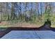 Spacious backyard with a concrete patio and natural surroundings offering a private and serene outdoor space at 500 Allen'S Landing Ct, Lawrenceville, GA 30045