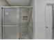 Bathroom with a tiled shower featuring a glass door and decorative inset at 500 Allen'S Landing Ct, Lawrenceville, GA 30045