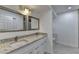 Modern bathroom with double sinks, granite countertops, and bright lighting fixtures at 500 Allen'S Landing Ct, Lawrenceville, GA 30045