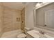 Bathroom showcasing bathtub, tiled walls, and vanity with mirror at 500 Allen'S Landing Ct, Lawrenceville, GA 30045