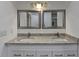 Stylish bathroom featuring double vanity with granite countertops and framed mirrors at 500 Allen'S Landing Ct, Lawrenceville, GA 30045