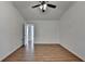 Bedroom showcasing wood-look floors, ceiling fan, and an open layout towards the bathroom at 500 Allen'S Landing Ct, Lawrenceville, GA 30045