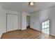 Bright bedroom featuring wood-look floors, a closet, and natural light streaming through the windows at 500 Allen'S Landing Ct, Lawrenceville, GA 30045