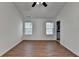 Clean bedroom with two windows, wood-look floors, and easy access to the bathroom at 500 Allen'S Landing Ct, Lawrenceville, GA 30045