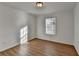 Bedroom with wood-look floors, window, and neutral paint at 500 Allen'S Landing Ct, Lawrenceville, GA 30045