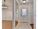 Inviting foyer with a view of the front door, dining area, and stylish light fixture at 500 Allen'S Landing Ct, Lawrenceville, GA 30045
