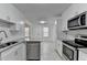 Bright kitchen features white cabinets, stainless steel appliances and granite countertops at 500 Allen'S Landing Ct, Lawrenceville, GA 30045