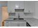 Kitchen featuring white cabinets, stainless steel appliances, and granite countertops at 500 Allen'S Landing Ct, Lawrenceville, GA 30045