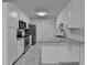 Modern kitchen featuring stainless steel appliances, white cabinetry, and granite countertops at 500 Allen'S Landing Ct, Lawrenceville, GA 30045