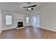 Cozy living room with a fireplace, vaulted ceilings, and large windows for natural light at 500 Allen'S Landing Ct, Lawrenceville, GA 30045