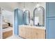 Bathroom featuring double sink vanity, pendant lights, and blue cabinets at 6641 Poplar Grove Way, Stone Mountain, GA 30087