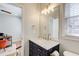 This stylish powder room boasts a marble countertop vanity with brass hardware and modern lighting at 6641 Poplar Grove Way, Stone Mountain, GA 30087