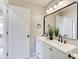 Bathroom featuring white vanity, double sinks, and a large mirror at 6641 Poplar Grove Way, Stone Mountain, GA 30087