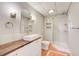 Modern bathroom showcasing a unique vanity, lighting fixtures, and a glass-enclosed shower at 6641 Poplar Grove Way, Stone Mountain, GA 30087