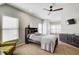 Bedroom featuring a ceiling fan, large windows, and built-in headboard at 6641 Poplar Grove Way, Stone Mountain, GA 30087