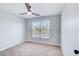 Bedroom featuring ceiling fan, a large window, and neutral carpet at 6641 Poplar Grove Way, Stone Mountain, GA 30087