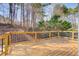 Wood deck with black metal railings overlooks a wooded backyard at 6641 Poplar Grove Way, Stone Mountain, GA 30087