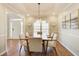 Elegant dining room with tray ceiling, stylish light, wainscoting and wood floors adjacent to front entry at 6641 Poplar Grove Way, Stone Mountain, GA 30087