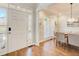 Elegant dining room with wood floors, stylish chandelier, and views of the front door and windows at 6641 Poplar Grove Way, Stone Mountain, GA 30087