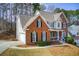 Beautiful two-story home with a brick exterior, dormers and manicured landscaping at 6641 Poplar Grove Way, Stone Mountain, GA 30087