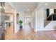Bright, open foyer with wood floors, recessed lighting, and view to kitchen and staircase at 6641 Poplar Grove Way, Stone Mountain, GA 30087