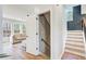Open hallway with a staircase, wood floors, natural light and entry to the living room at 6641 Poplar Grove Way, Stone Mountain, GA 30087