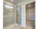 Bathroom showcasing a glass shower stall, window, and vinyl floors, plus access to a closet at 129 Belvedere Rd, Mcdonough, GA 30253