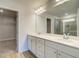 Bathroom boasts a double vanity, vinyl floors, and a glass shower stall, plus access to a closet at 129 Belvedere Rd, Mcdonough, GA 30253