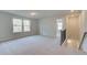 Upstairs bonus room with neutral carpeting and abundant natural light from the double windows at 129 Belvedere Rd, Mcdonough, GA 30253