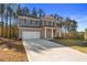 Inviting two-story home with a spacious driveway and well-maintained lawn at 129 Belvedere Rd, Mcdonough, GA 30253