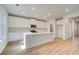 Bright kitchen with white cabinets, stainless appliances, and a large center island at 129 Belvedere Rd, Mcdonough, GA 30253