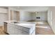 Well-lit kitchen with a large island flowing into the expansive living area at 129 Belvedere Rd, Mcdonough, GA 30253