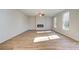 Bright and airy living room featuring luxury vinyl plank flooring and a modern electric fireplace at 129 Belvedere Rd, Mcdonough, GA 30253
