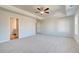 Spacious main bedroom with tray ceilings, neutral carpet, and a ceiling fan with lighting at 129 Belvedere Rd, Mcdonough, GA 30253