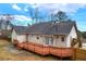 Backyard featuring large wooden deck, brick patio, and privacy fence at 135 Cowan Trl, Stockbridge, GA 30281