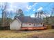 Backyard featuring a large wooden deck and a view of the treeline at 135 Cowan Trl, Stockbridge, GA 30281
