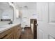 Bright bathroom featuring double vanity, tile floors, and a separate toilet area at 135 Cowan Trl, Stockbridge, GA 30281