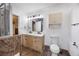 Bright bathroom with double vanity, framed mirror, and tile floors with a separated toilet at 135 Cowan Trl, Stockbridge, GA 30281