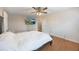 Cozy bedroom featuring a ceiling fan, wood-look floors, neutral colors, and a door leading to another room at 135 Cowan Trl, Stockbridge, GA 30281