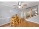 Bright breakfast area with hardwood floors, a ceiling fan, and a view into the adjacent living space at 135 Cowan Trl, Stockbridge, GA 30281