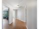 Hallway with views into an adjacent living room and bathroom featuring neutral paint and laminate flooring at 135 Cowan Trl, Stockbridge, GA 30281