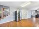 Bright open kitchen with hardwood floors and a stainless steel refrigerator at 135 Cowan Trl, Stockbridge, GA 30281