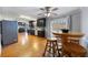 Eat-in kitchen boasting stainless steel appliances, dark cabinetry, hardwood floors, and a view of the backyard at 135 Cowan Trl, Stockbridge, GA 30281