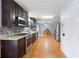 Kitchen features stainless appliances, dark wood cabinets, granite counters, and tiled backsplash at 135 Cowan Trl, Stockbridge, GA 30281
