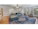 Comfortable living room with hardwood floors, large windows offering natural light, and a stylish blue sofa at 135 Cowan Trl, Stockbridge, GA 30281