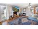 Inviting living area showcasing a fireplace, hardwood floors, bright window and a staircase at 135 Cowan Trl, Stockbridge, GA 30281