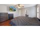 Main bedroom features a ceiling fan, hardwood floors, and a wall-mounted television at 135 Cowan Trl, Stockbridge, GA 30281