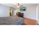 Main bedroom features a ceiling fan, hardwood floors, and a wall-mounted television at 135 Cowan Trl, Stockbridge, GA 30281