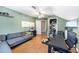 Well-lit office with a corner couch and a black desk, perfect for a productive work environment at 135 Cowan Trl, Stockbridge, GA 30281